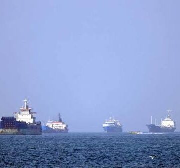 Military vessels near the Strait of Hormuz amid renewed US blockade on Iranian ports and rising Middle East tensions.